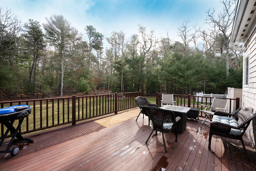 527 County Road Pocasset, MA 02559 - Photo 21 of 25 a balcony with wooden floor table and chairs