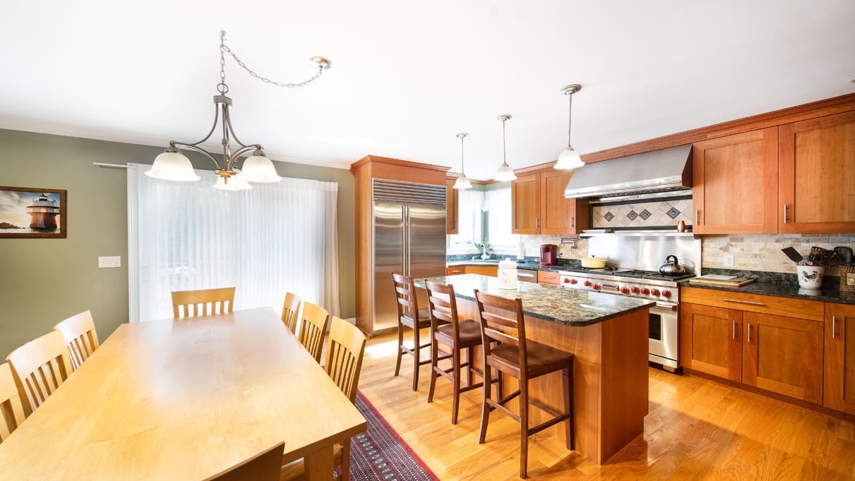 527 County Road Pocasset, MA 02559 - Photo 4 of 25 a kitchen with stainless steel appliances granite countertop a sink a stove and a wooden floors