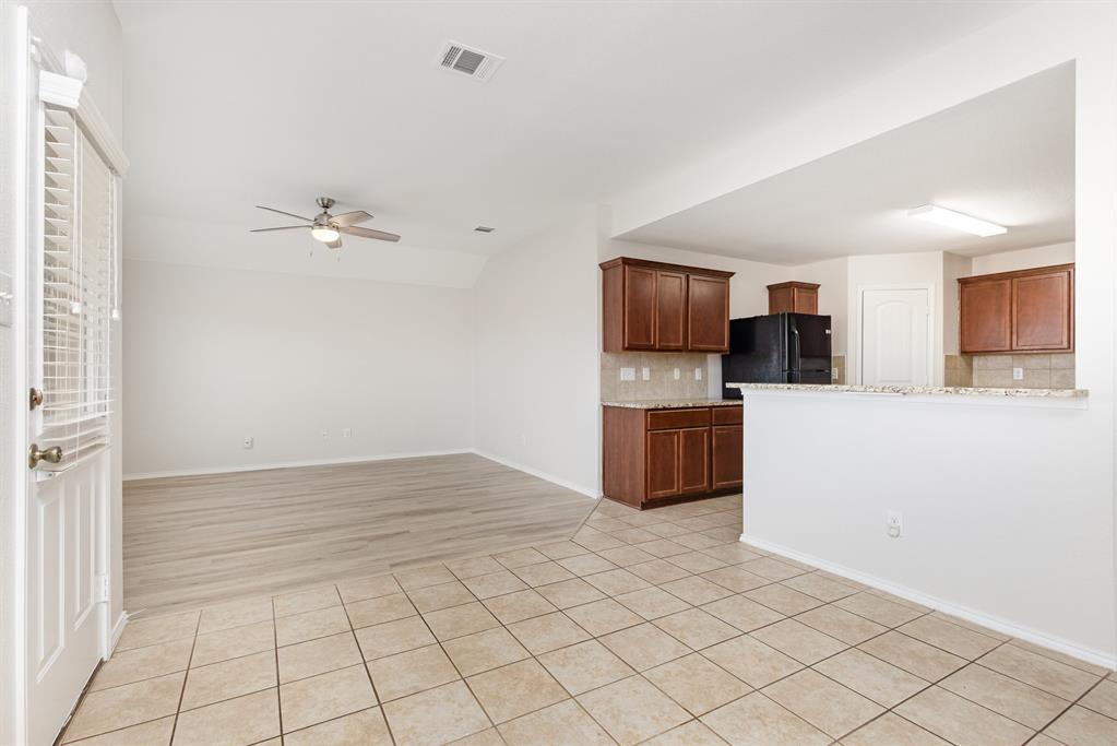 1025 Bend Court Forney, TX 75126 - Photo 3 of 12 a kitchen with granite countertop a sink and cabinets