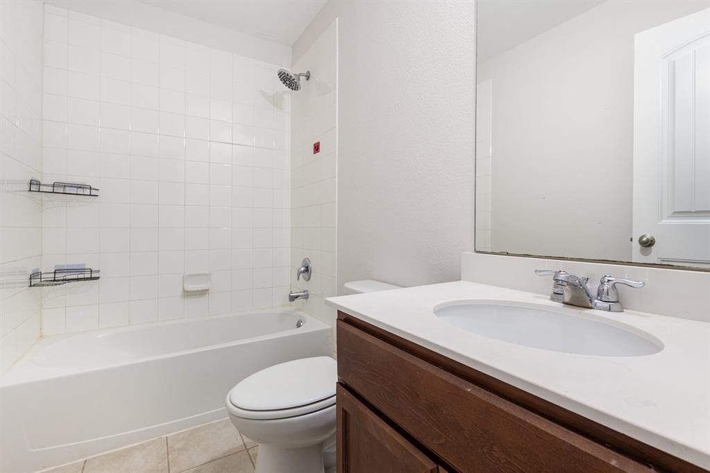1025 Bend Court Forney, TX 75126 - Photo 9 of 12 a bathroom with a sink a toilet and a bathtub