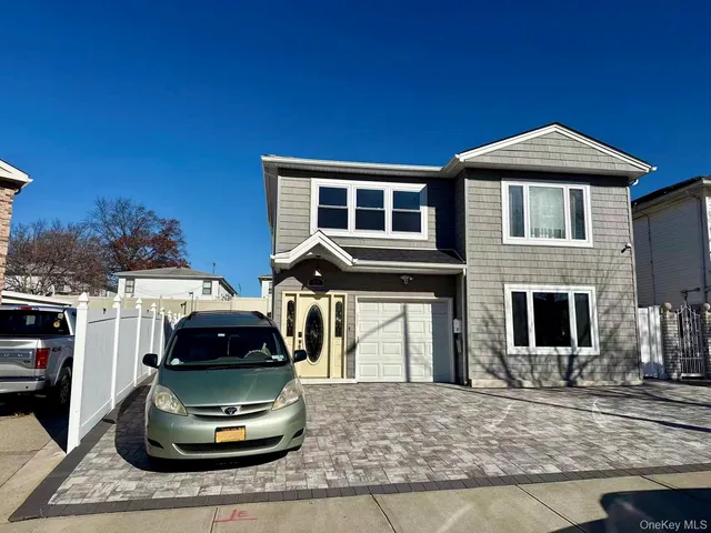 a front view of a house with parking space