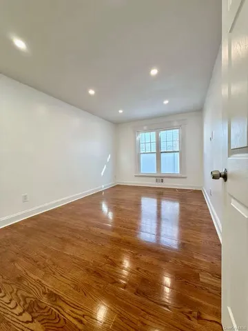 an empty room with wooden floor