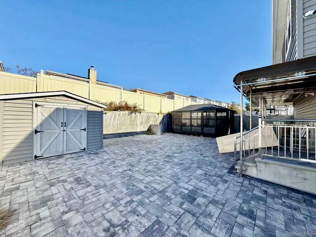 a bathroom with a granite countertop sink a toilet a mirror and shower