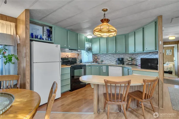 a kitchen with a dining table and chairs