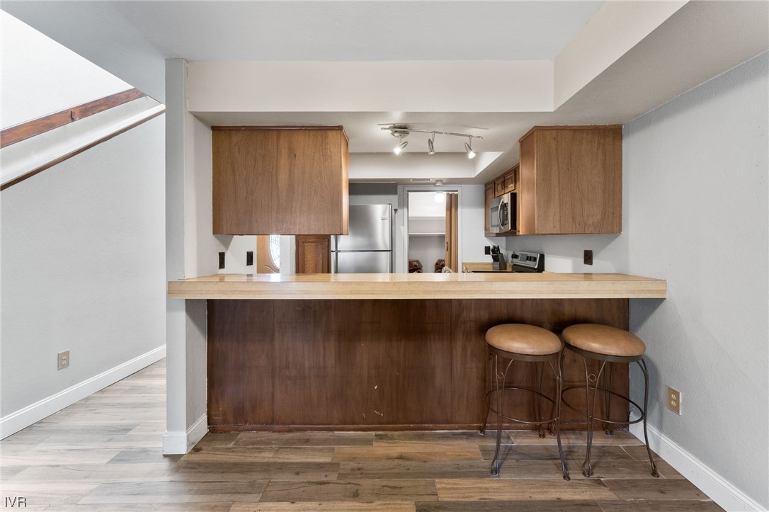4185 Baker Lane, Unit 4185 Reno, NV 89509 - Photo 12 of 30 a kitchen with a sink cabinets and wooden floor