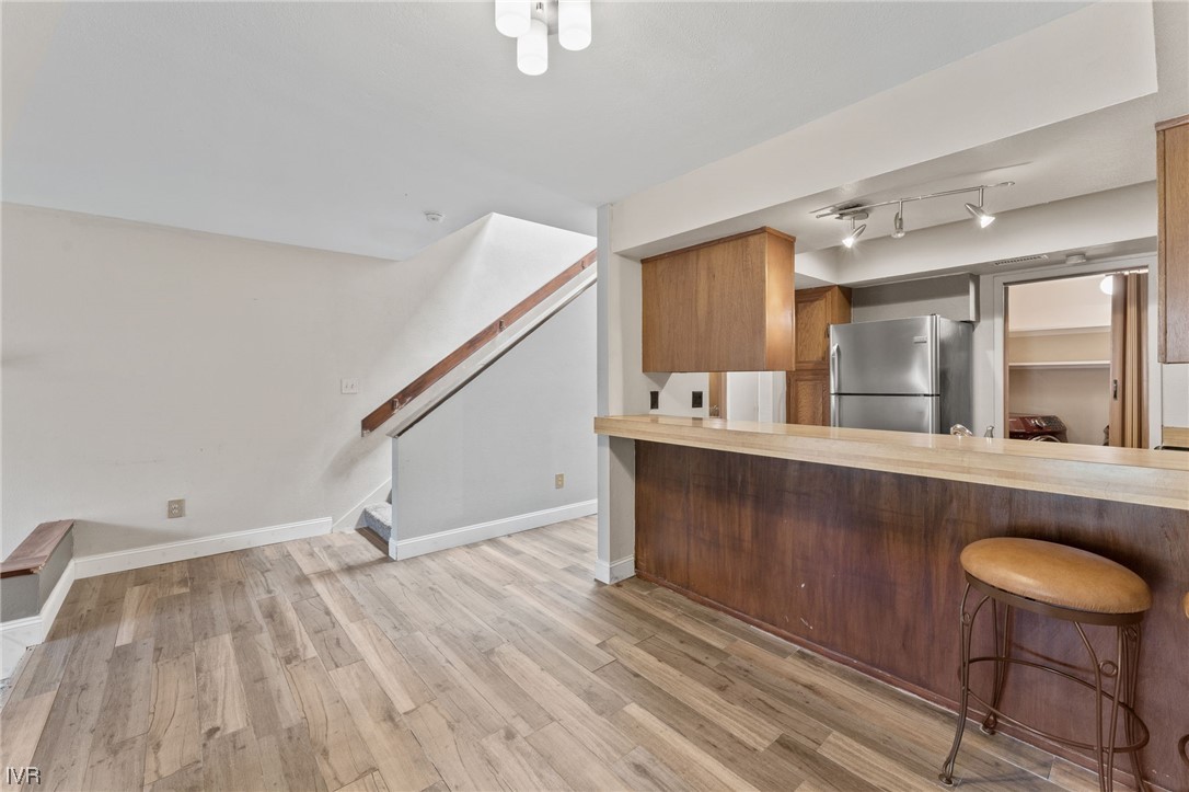 4185 Baker Lane, Unit 4185 Reno, NV 89509 - Photo 13 of 30 a view of kitchen and hall with wooden floor