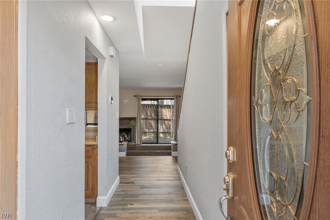 4185 Baker Lane, Unit 4185 Reno, NV 89509 - Photo 2 of 30 a view of a hallway with wooden floor and glass door