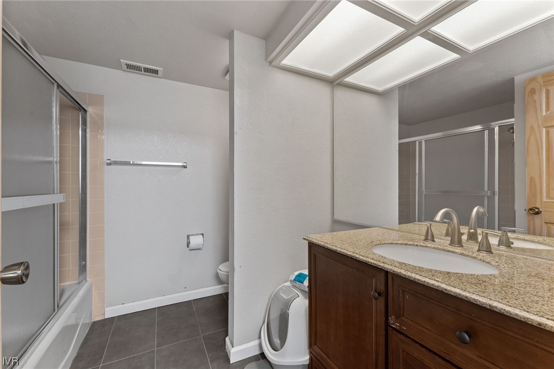 4185 Baker Lane, Unit 4185 Reno, NV 89509 - Photo 22 of 30 a bathroom with a granite countertop sink and a mirror