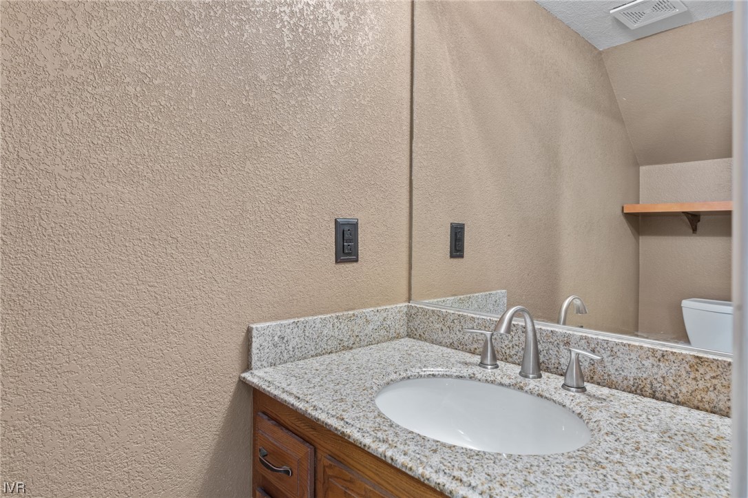 4185 Baker Lane, Unit 4185 Reno, NV 89509 - Photo 25 of 30 a bathroom with a granite countertop sink and a mirror