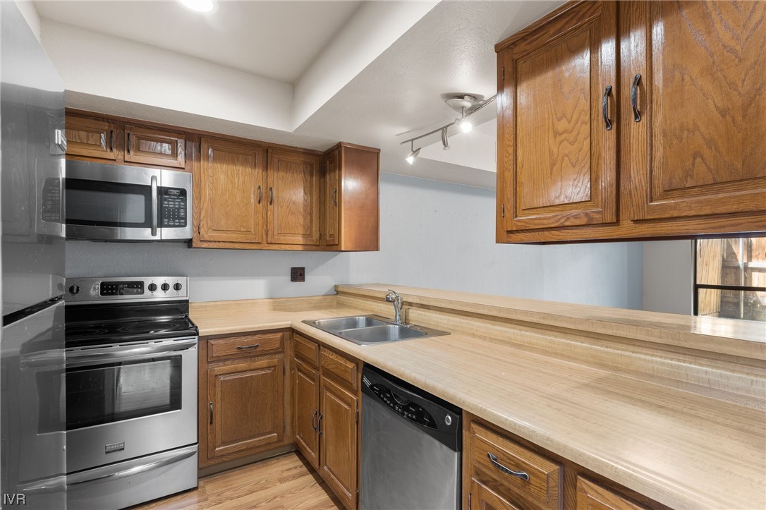 4185 Baker Lane, Unit 4185 Reno, NV 89509 - Photo 5 of 30 a kitchen with stainless steel appliances granite countertop a sink and a stove