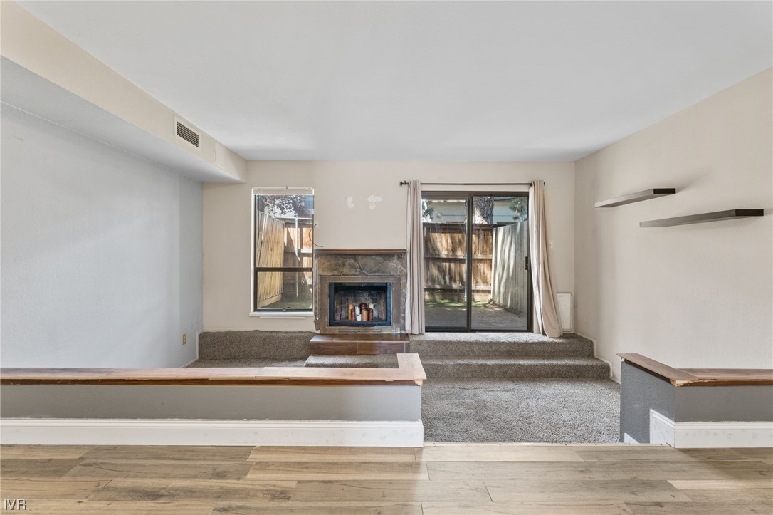 4185 Baker Lane, Unit 4185 Reno, NV 89509 - Photo 7 of 30 a living room with a fireplace and a floor to ceiling window