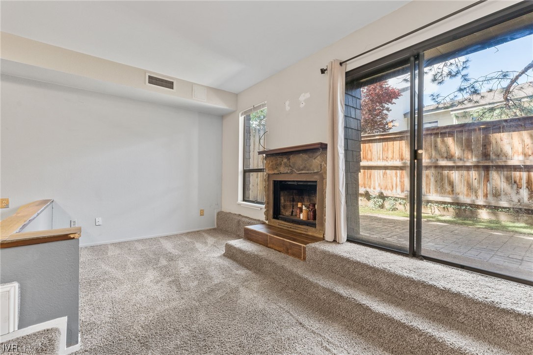 4185 Baker Lane, Unit 4185 Reno, NV 89509 - Photo 8 of 30 a view of an empty room with a fireplace
