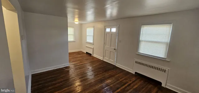 a view of hallway with wooden floor