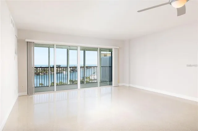 an empty room with windows and city view