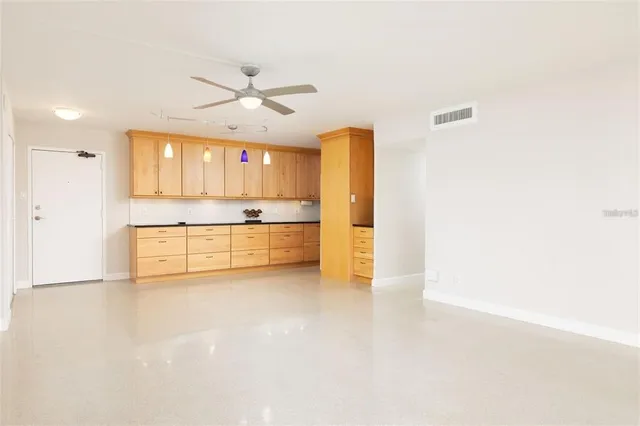 a view of a kitchen with a sink and a refrigerator