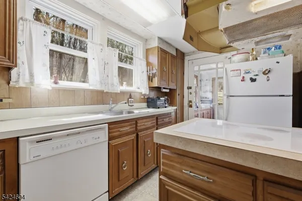 a kitchen with a refrigerator and a sink