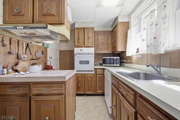 a kitchen with a sink stove and cabinets
