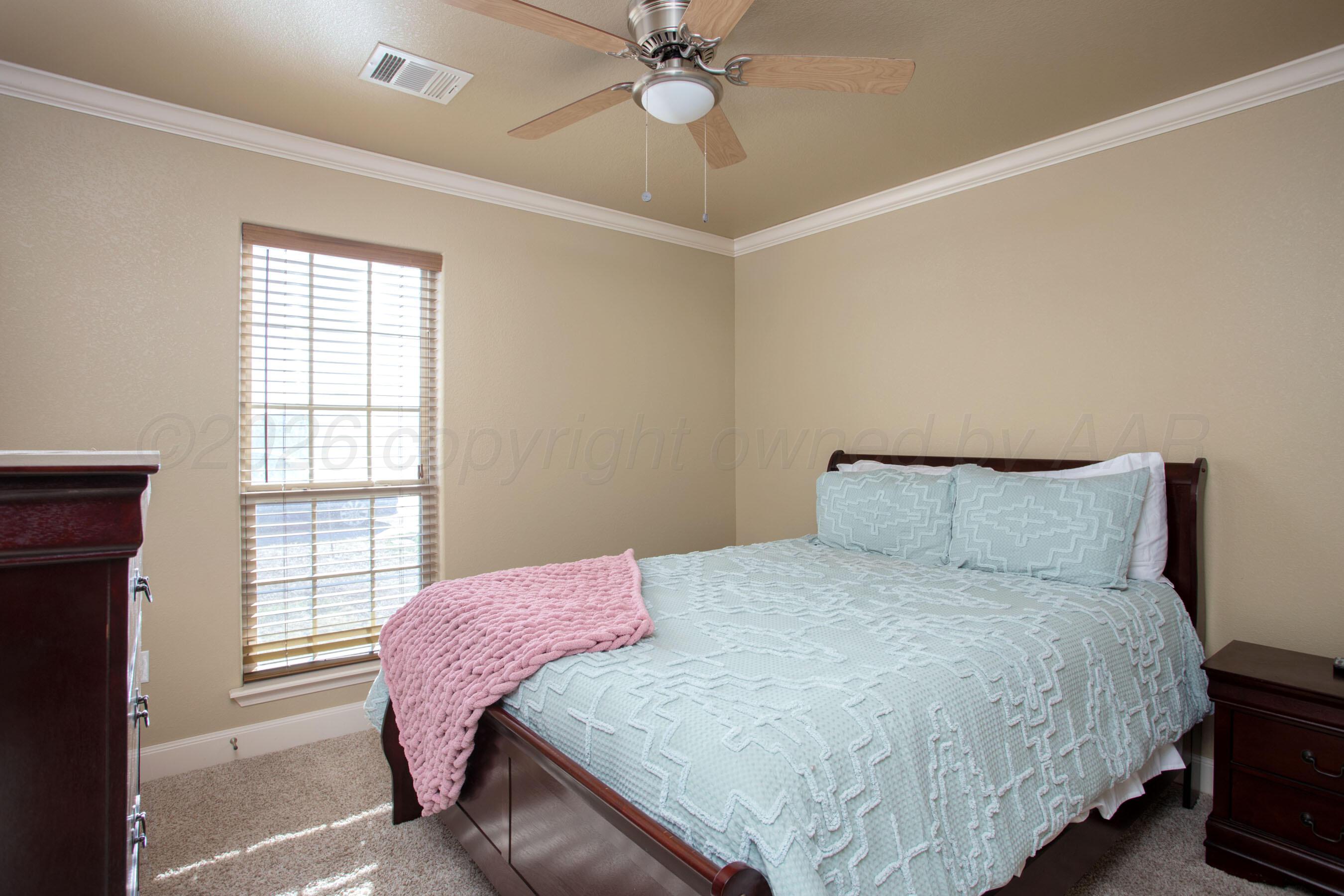 4812 Gloster Street Amarillo, TX 79118 - Photo 9 of 16 a bedroom with a bed and two window