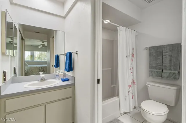 a bathroom with a toilet a sink and shower