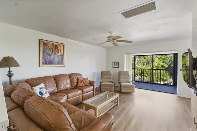 a living room with furniture and a large window with outer view