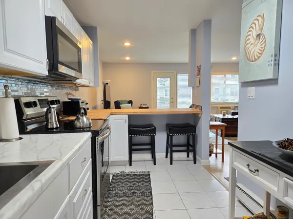 a kitchen with stainless steel appliances granite countertop a sink dishwasher stove and refrigerator