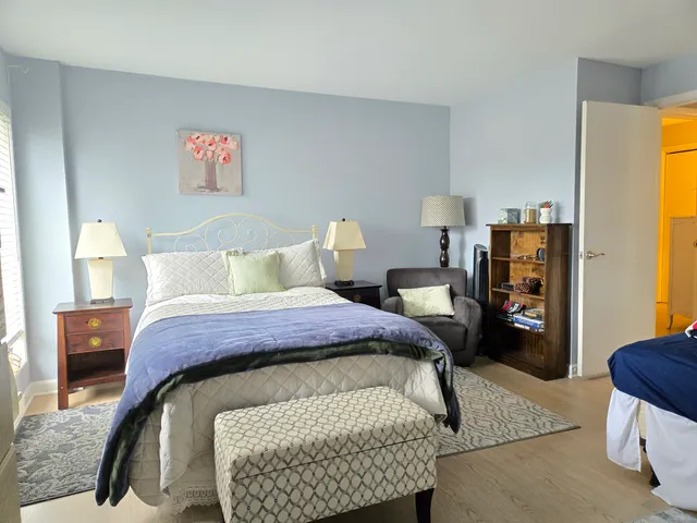 a bedroom with a bed and glass window