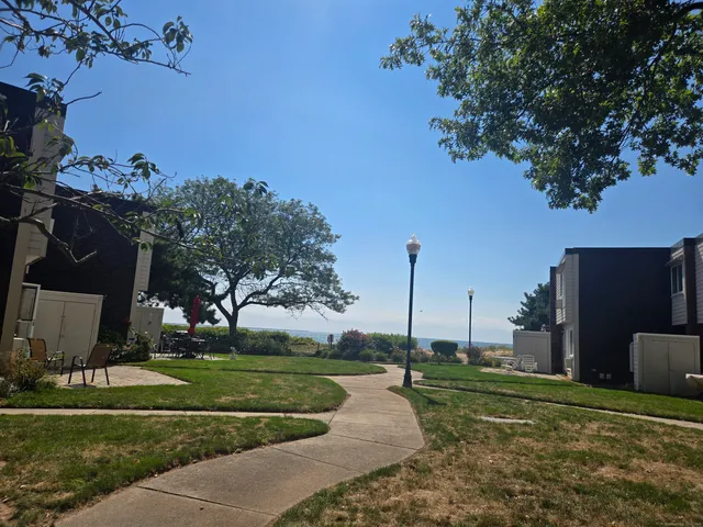 a view of a house with backyard and sitting area