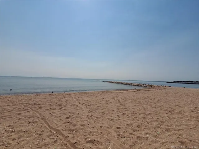 a kitchen with sink a stove and cabinets
