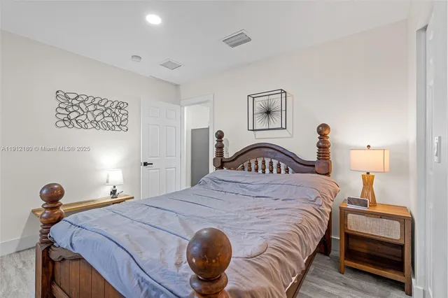 a bedroom with a bed and a lamp