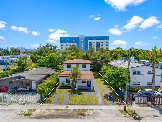 an aerial view of a house with a yard basket ball court and outdoor seating