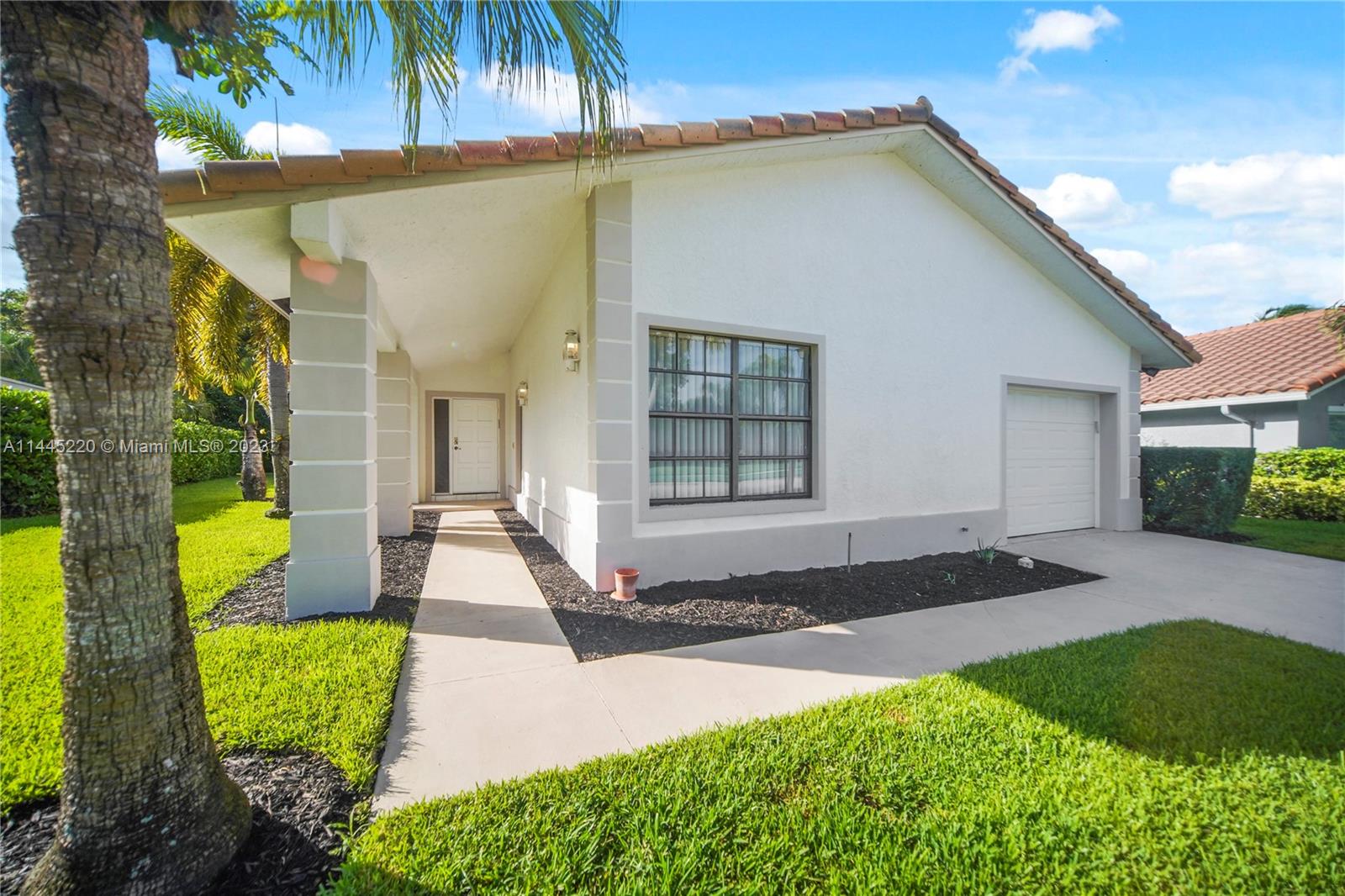 10161 Camelback Lane Boca Raton, FL 33498 - Photo 1 of 24 a front view of a house with garden