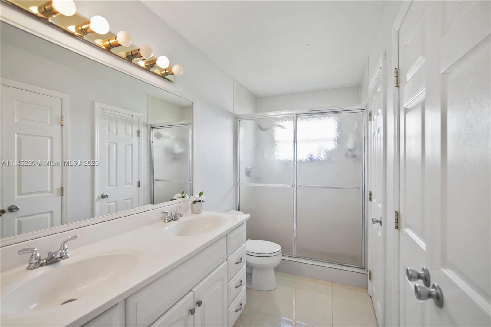 10161 Camelback Lane Boca Raton, FL 33498 - Photo 12 of 24 a bathroom with a sink a toilet and shower