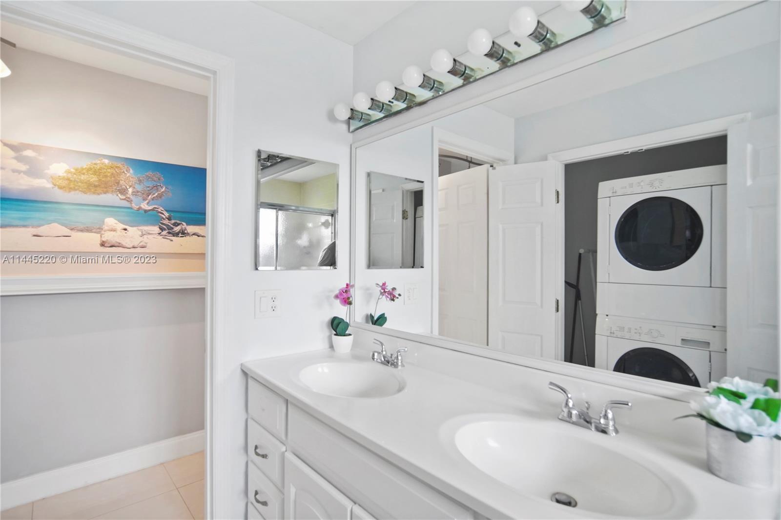 10161 Camelback Lane Boca Raton, FL 33498 - Photo 13 of 24 a bathroom with a granite countertop sink a large mirror and a shower
