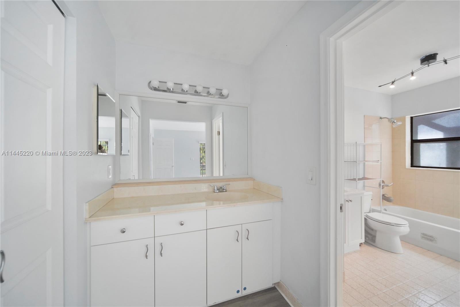 10161 Camelback Lane Boca Raton, FL 33498 - Photo 18 of 24 a bathroom with a sink a toilet and a mirror