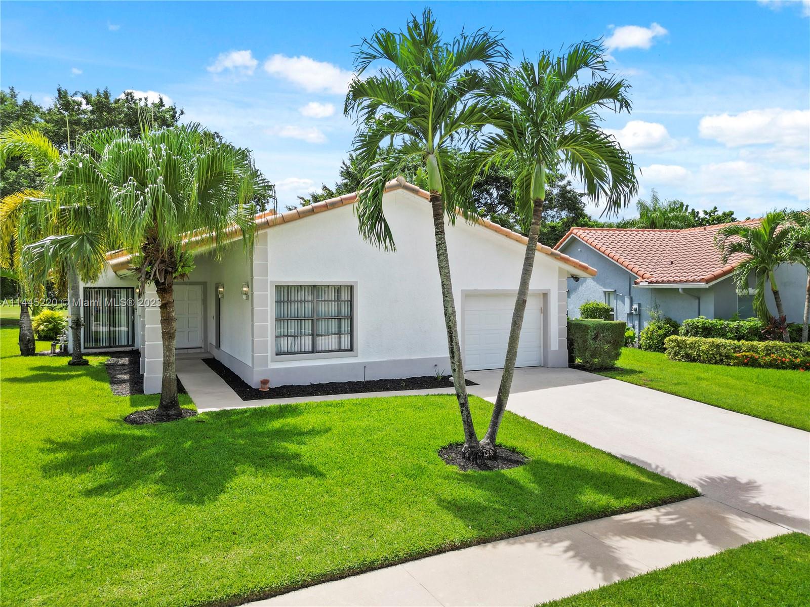 10161 Camelback Lane Boca Raton, FL 33498 - Photo 23 of 24 a house that has a tree in front of it