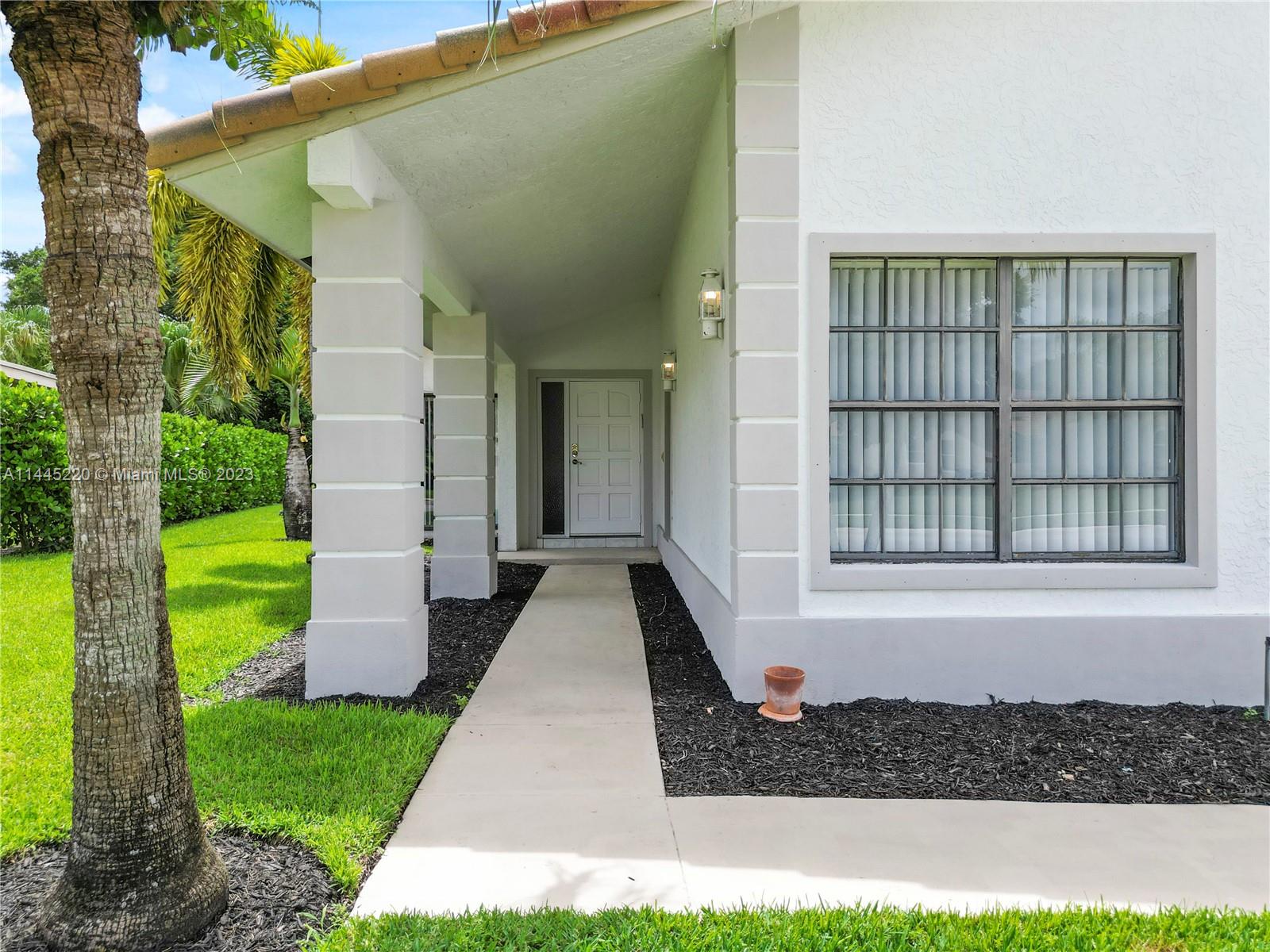 10161 Camelback Lane Boca Raton, FL 33498 - Photo 24 of 24 a front view of a house with a yard