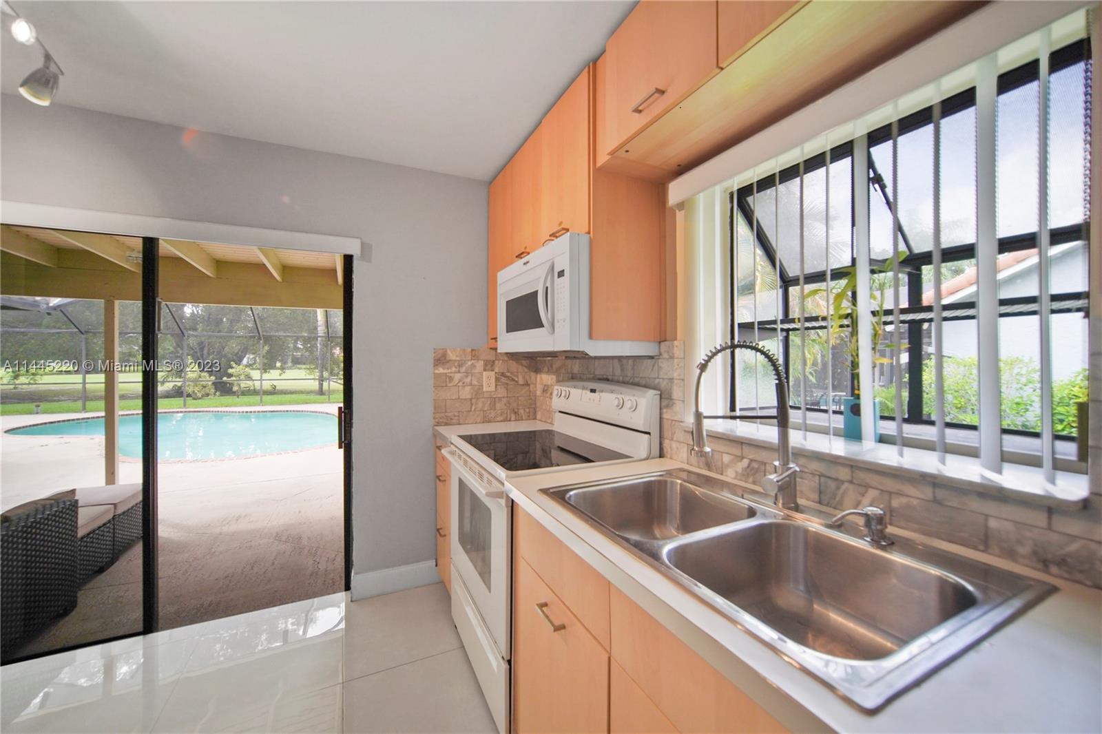 10161 Camelback Lane Boca Raton, FL 33498 - Photo 7 of 24 a kitchen that has a sink and a large window