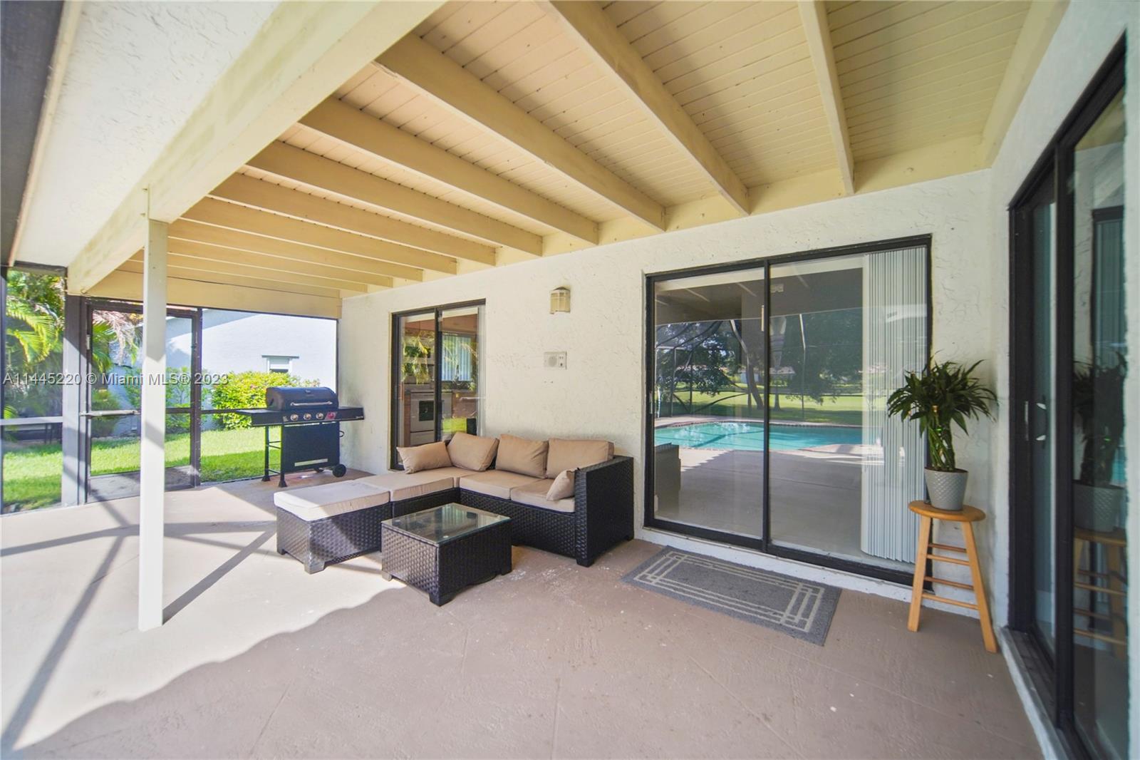10161 Camelback Lane Boca Raton, FL 33498 - Photo 8 of 24 a living room with patio furniture and garden