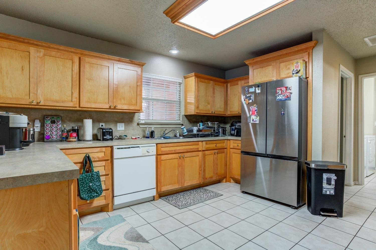 3114 109th Street Lubbock, TX 79423 - Photo 11 of 43 a kitchen with stainless steel appliances granite countertop a refrigerator and a stove top oven
