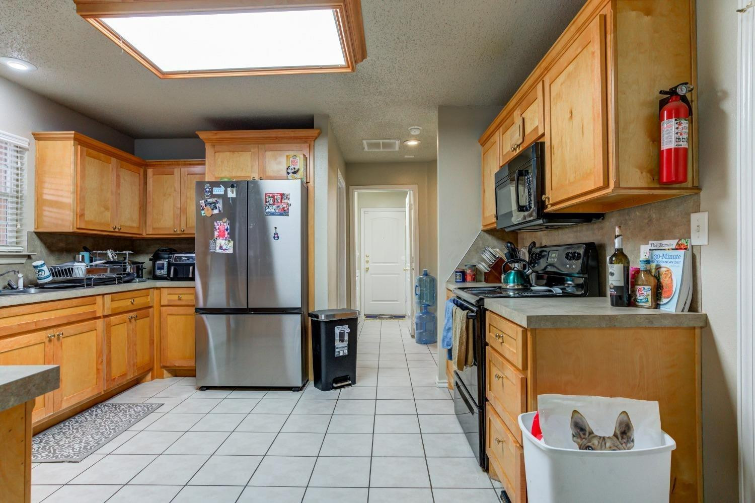 3114 109th Street Lubbock, TX 79423 - Photo 12 of 43 a kitchen with stainless steel appliances granite countertop a refrigerator and a stove top oven