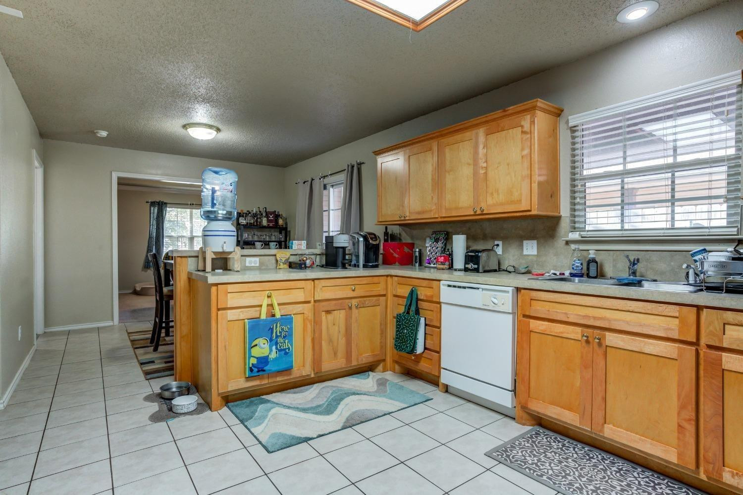 3114 109th Street Lubbock, TX 79423 - Photo 13 of 43 a kitchen with stainless steel appliances granite countertop a sink counter space cabinets and a large window