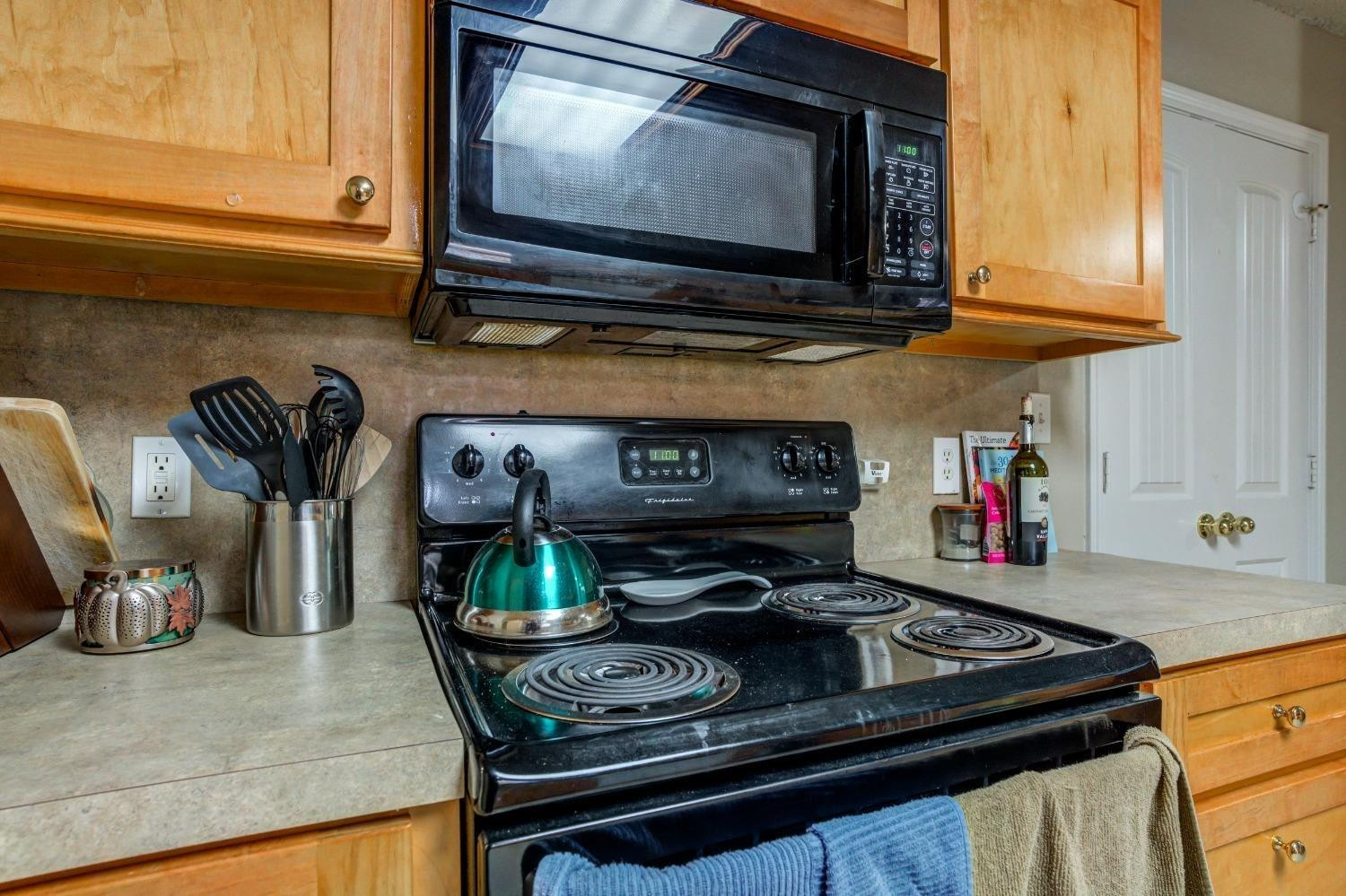 3114 109th Street Lubbock, TX 79423 - Photo 14 of 43 a kitchen with a stove and a microwave