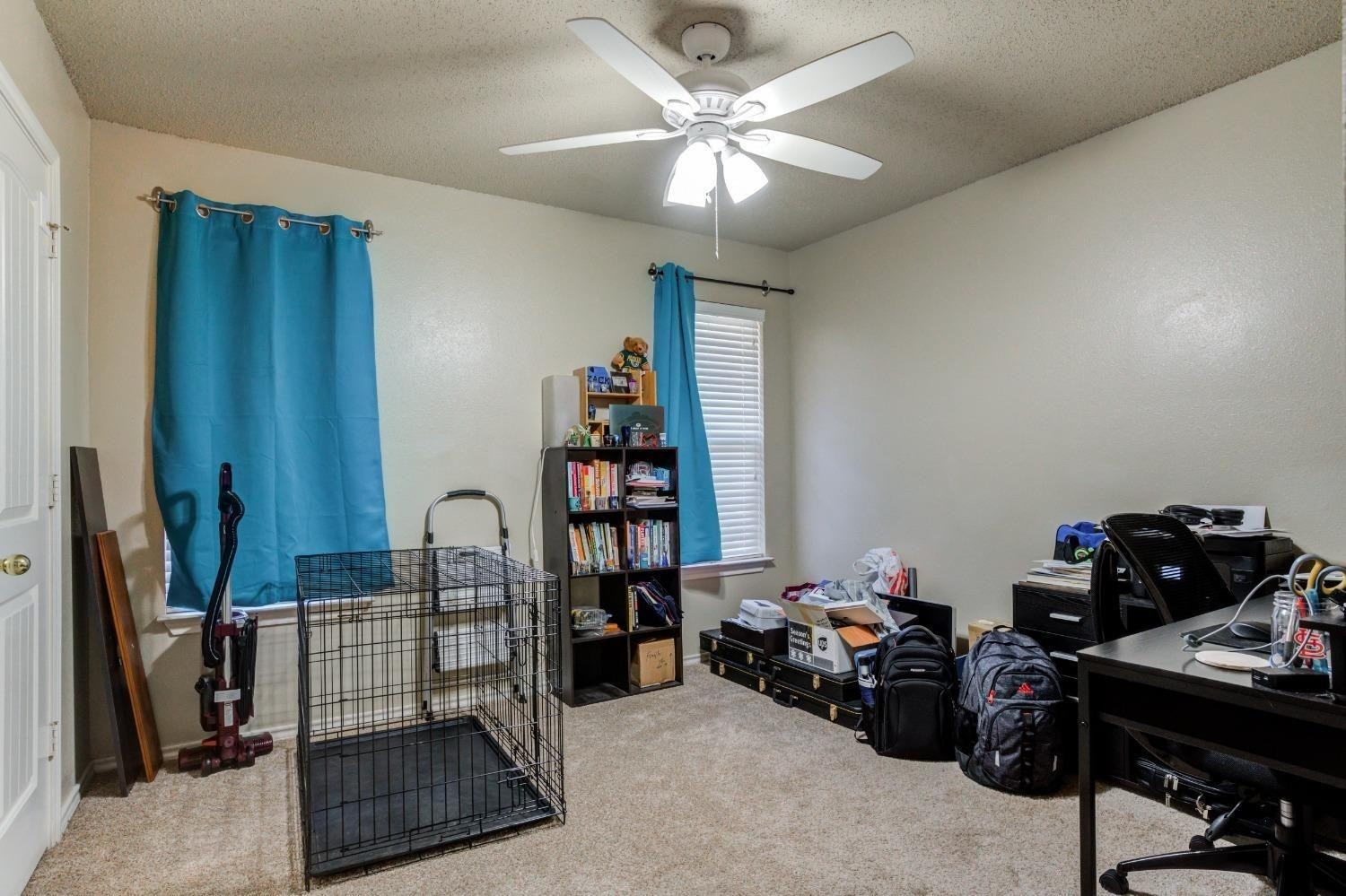 3114 109th Street Lubbock, TX 79423 - Photo 21 of 43 a view of a workspace with furniture and a window