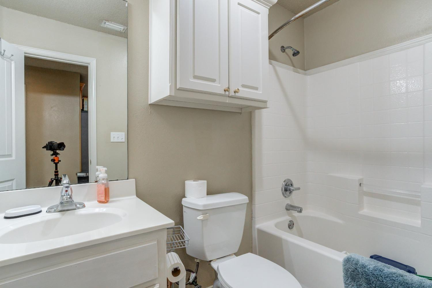 3114 109th Street Lubbock, TX 79423 - Photo 24 of 43 a bathroom with a sink a toilet and bathtub