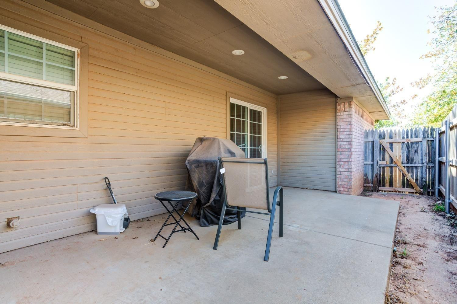 3114 109th Street Lubbock, TX 79423 - Photo 29 of 43 a view of a workspace with furniture and a gate