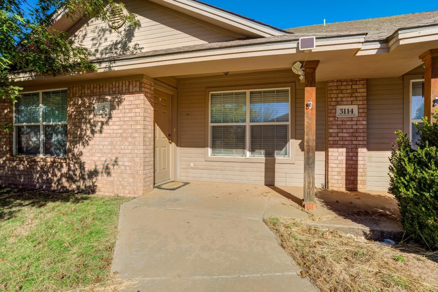 3114 109th Street Lubbock, TX 79423 - Photo 3 of 43 a front view of a house with a yard