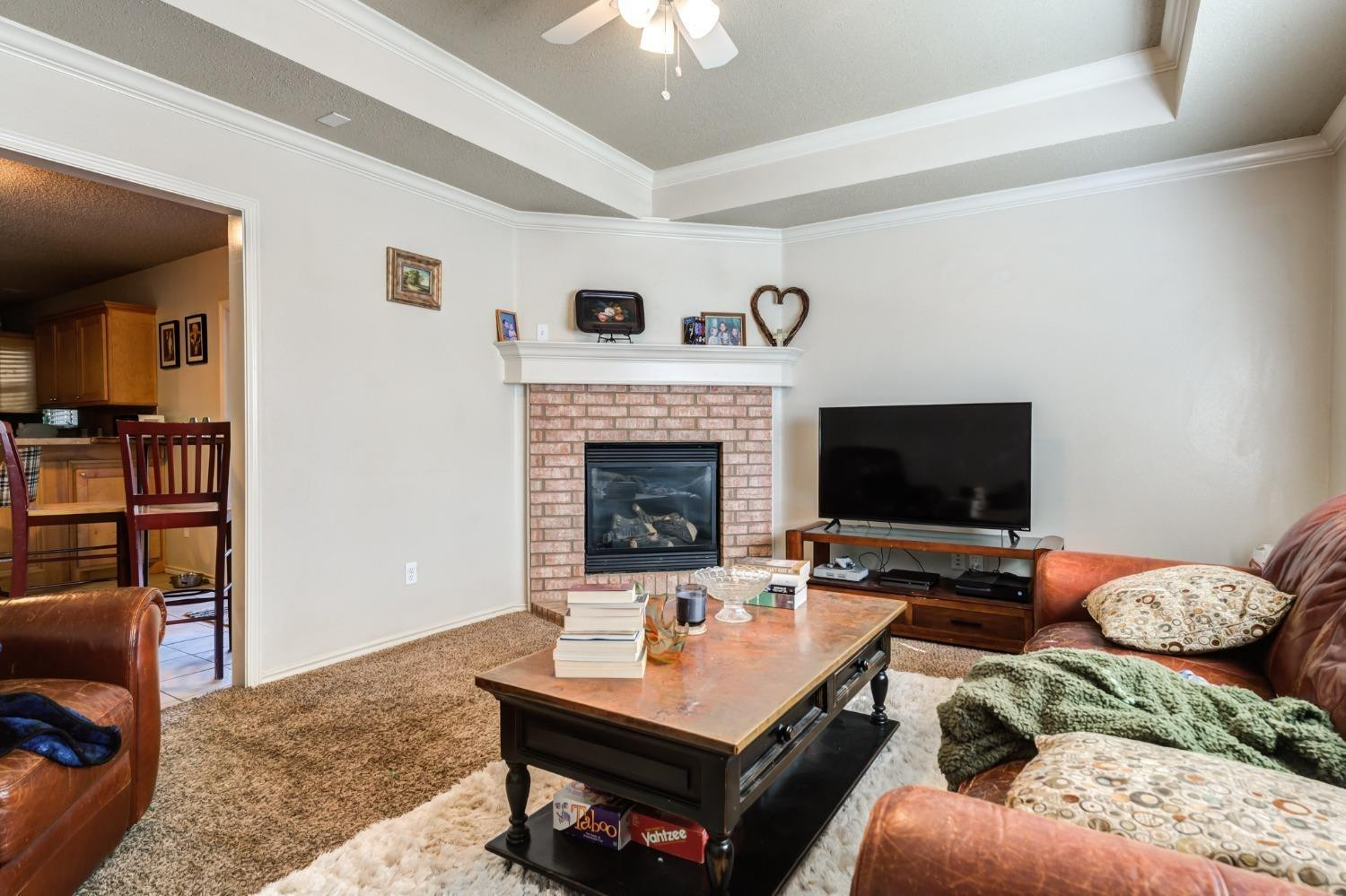 3114 109th Street Lubbock, TX 79423 - Photo 31 of 43 a living room with furniture and a fireplace
