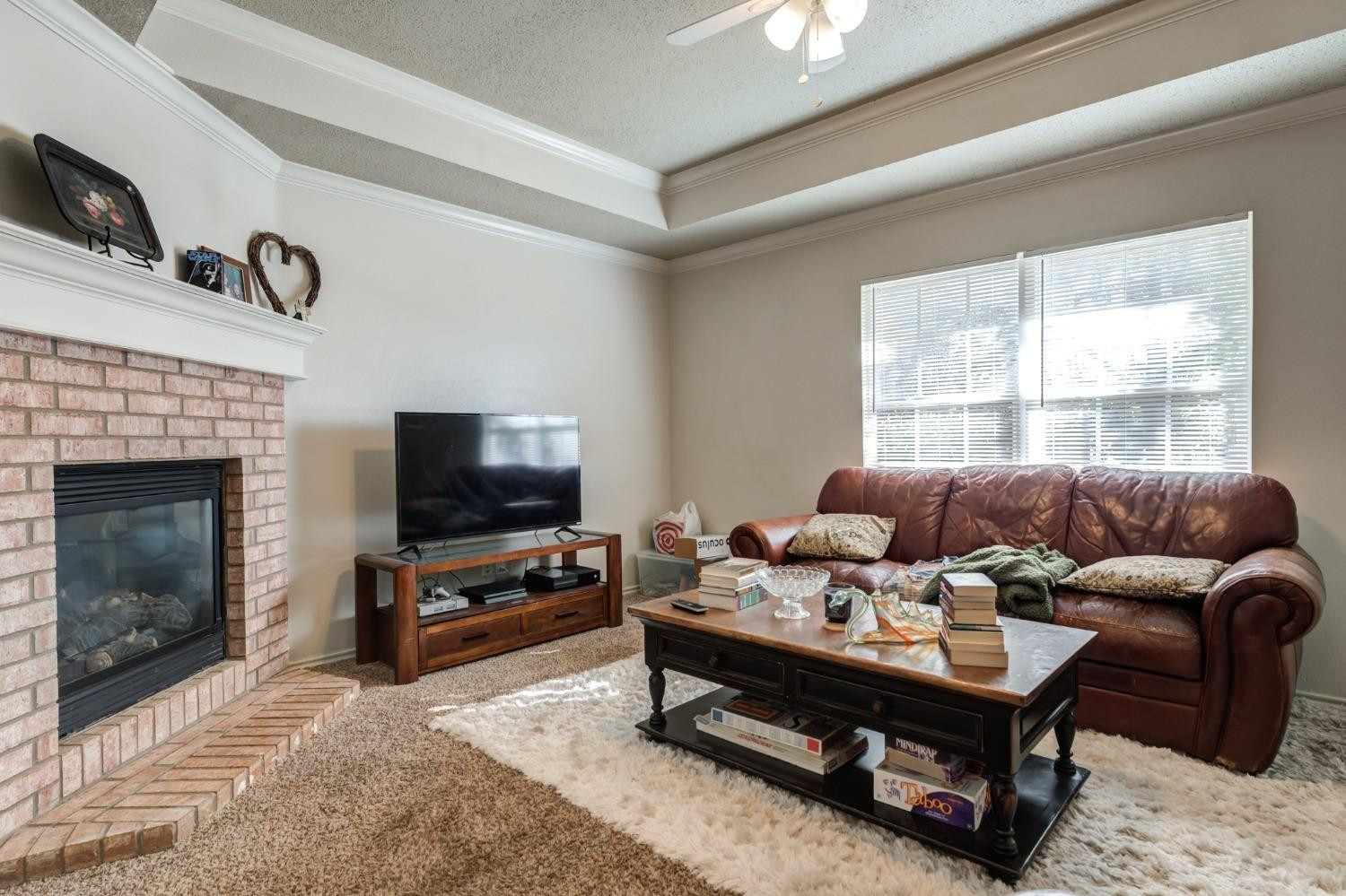 3114 109th Street Lubbock, TX 79423 - Photo 32 of 43 a living room with furniture and a flat screen tv