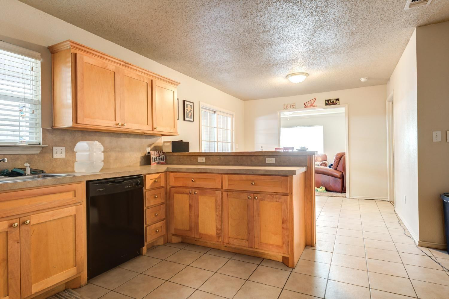 3114 109th Street Lubbock, TX 79423 - Photo 37 of 43 a kitchen with stainless steel appliances granite countertop a sink and cabinets