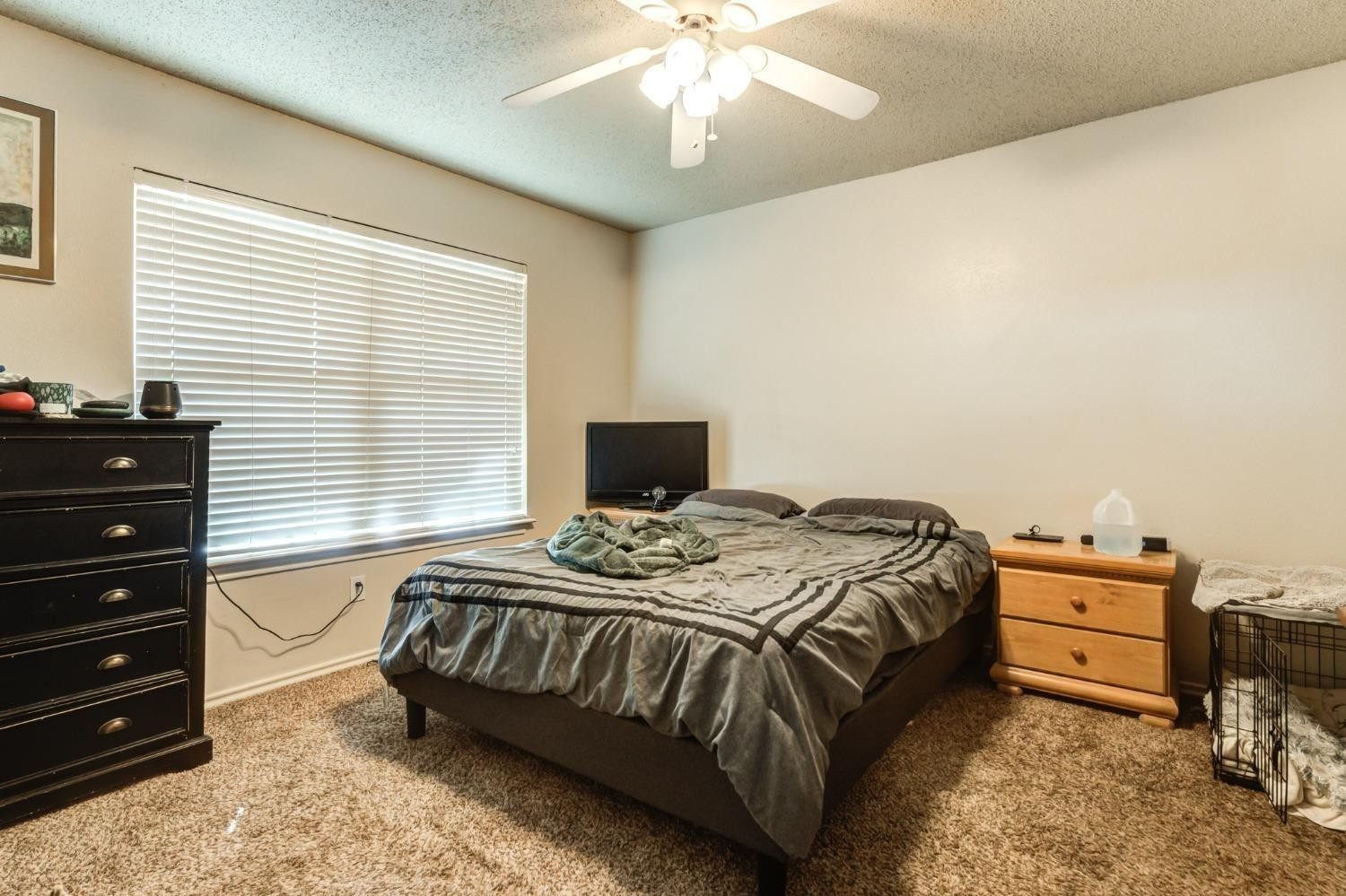 3114 109th Street Lubbock, TX 79423 - Photo 41 of 43 a bedroom with a bed and a window